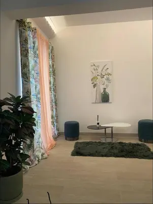 a living room with a table and a plant at Όνειρα γλυκα in Athens