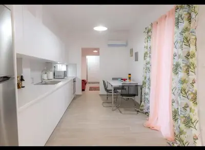 a kitchen with a counter and a table in a room at Όνειρα γλυκα in Athens