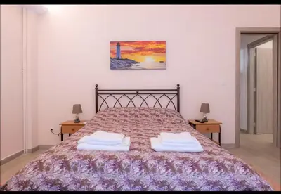 a bedroom with a bed with two towels on it at Όνειρα γλυκα in Athens