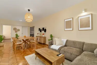 a living room with a couch and a table at Ofi Continental - 3BR, Koukaki in Athens