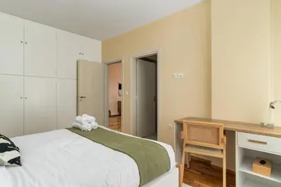 a bedroom with a bed and a desk and a desk at Ofi Continental - 3BR, Koukaki in Athens