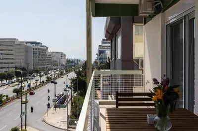 a balcony with a vase of flowers on a building at Ofi Continental - 3BR, Koukaki in Athens