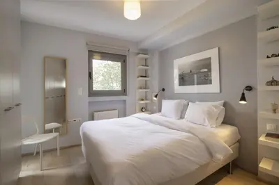 a bedroom with a large white bed and a desk at Elegant Design Stay in Koukaki in Athens