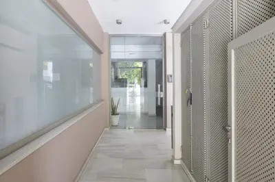 a hallway with a door leading into a room with a plant at Elegant Design Stay in Koukaki in Athens