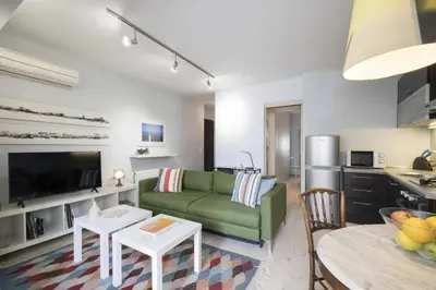 a living room with a green couch and a table at Elegant Design Stay in Koukaki in Athens