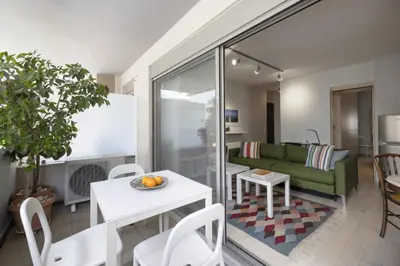 a living room with a green couch and a table at Elegant Design Stay in Koukaki in Athens