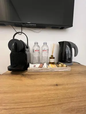 a table with two bottles of water and a coffee maker at Μοντέρνο στούντιο στην Καλλιθέα in Athens