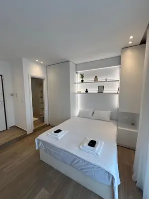 a bedroom with a large white bed in a room at Μοντέρνο στούντιο στην Καλλιθέα in Athens