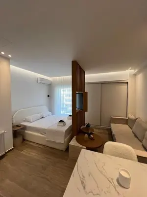 a large bedroom with a bed and a couch at Luxury Apartment in Athens in Athens