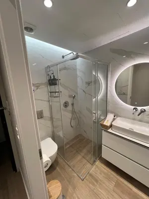 a bathroom with a shower and a toilet and a sink at Luxury Apartment in Athens in Athens