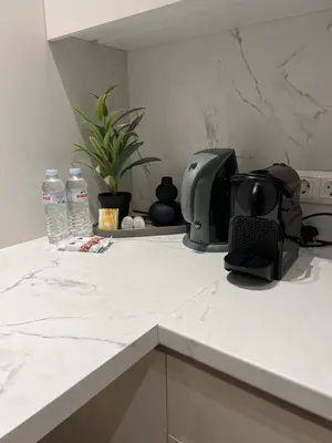 a kitchen counter with a toaster and water bottles at Luxury Apartment in Athens in Athens