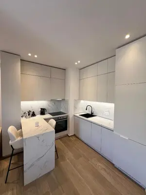 a kitchen with white cabinets and a sink and a counter at Luxury Apartment in Athens in Athens