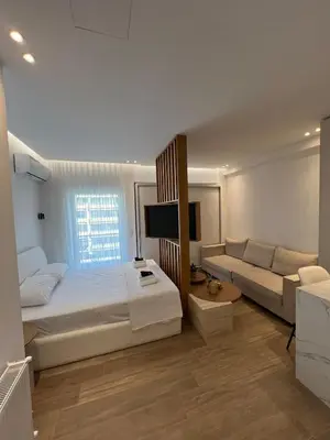 a bedroom with a large bed and a couch at Luxury Apartment in Athens in Athens
