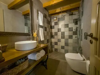 a bathroom with a sink and a toilet at Strofilia House Near ATH Airport in Markopoulo