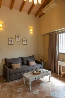 a living room with a couch and a coffee table at Strofilia House Near ATH Airport in Markopoulo