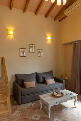 a living room with a couch and a coffee table at Strofilia House Near ATH Airport in Markopoulo