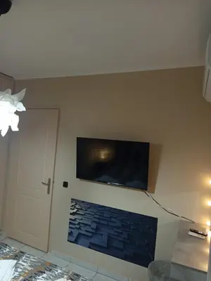 a room with a wall with a flat screen tv at Chrysa's house in Piraeus