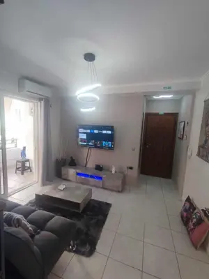 a living room with a couch and a tv at Chrysa's house in Piraeus