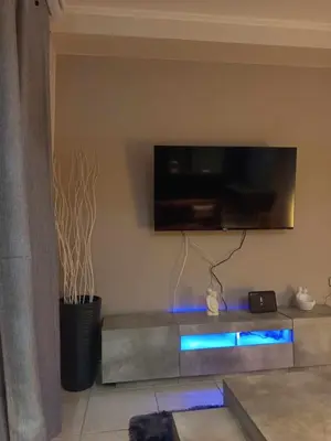 a living room with a flat screen tv on the wall at Chrysa's house in Piraeus