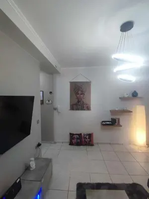 a living room with a flat screen tv on the wall at Chrysa's house in Piraeus