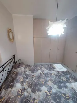 a bedroom with a bed and a chandelier at Chrysa's house in Piraeus