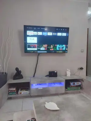 a living room with a television on a wall at Chrysa's house in Piraeus
