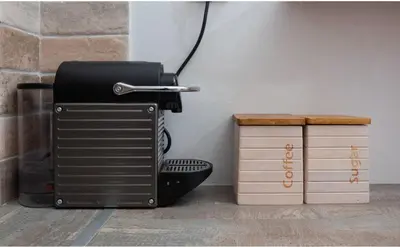 a black appliance sitting on the floor next to two boxes at Forest Dreams Penthouse in Athens