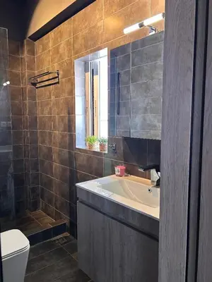 a bathroom with a tub and a sink and a toilet at Ben's Penthouse Athens in Athens