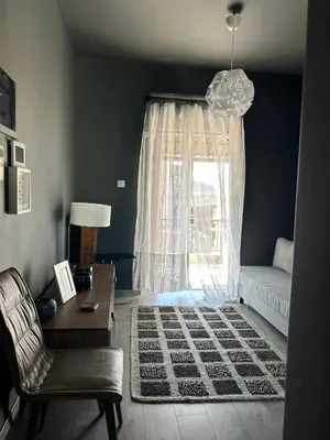 a living room with a couch and a window at Ben's Penthouse Athens in Athens