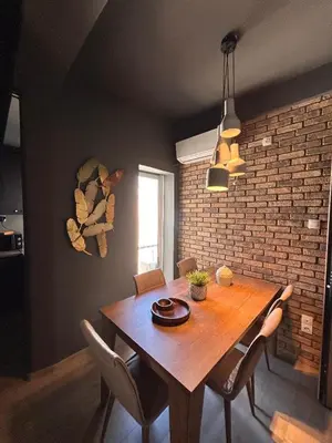 a dining room with a wooden table and chairs at Ben's Penthouse Athens in Athens