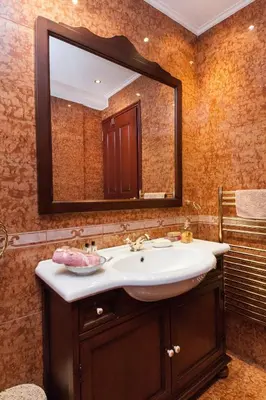 a bathroom with a sink and a large mirror at Stunning villa with private pool in Alimos Athens in Athens