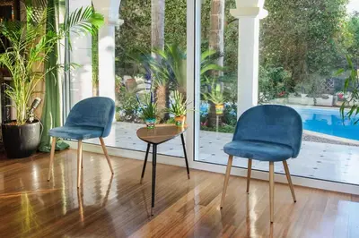two chairs and a table in a room with a pool at Stunning villa with private pool in Alimos Athens in Athens