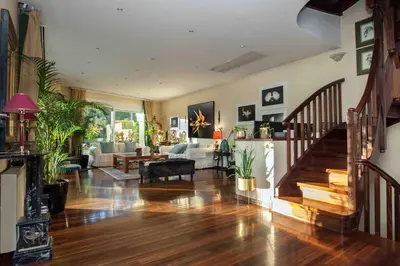 a large living room with a staircase and a living room at Stunning villa with private pool in Alimos Athens in Athens