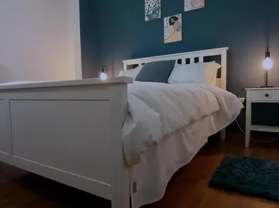 a bedroom with a white bed and a blue wall at Urban Pop Athens - City & Culture in Athens