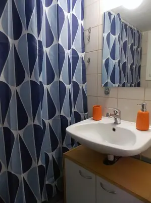 a bathroom with a sink and blue and white tiles at Urban Pop Athens - City & Culture in Athens