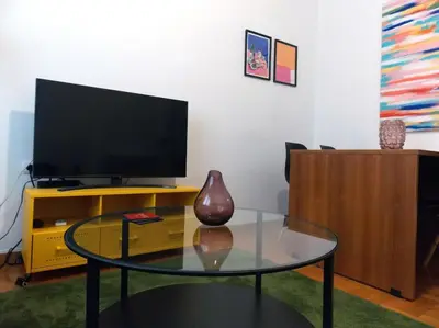 a living room with a tv and a glass table at Urban Pop Athens - City & Culture in Athens