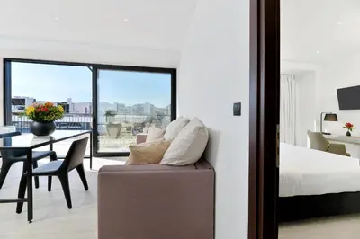 a bedroom with a bed and a table with a dining room at The Apartment by Athenaeum Hotels in Athens