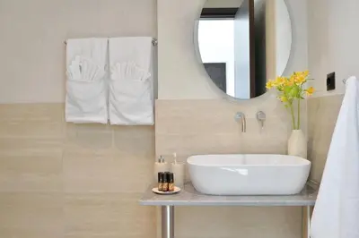 a bathroom with a white sink and a mirror at The Apartment by Athenaeum Hotels in Athens