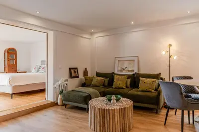a living room with a couch and a bed at Delimare, Acropolis & Sea View Rooftop, Paleo Faliro in Athens