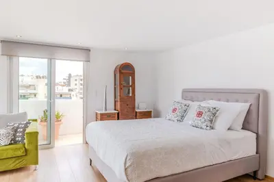 a white bedroom with a bed and a balcony at Delimare, Acropolis & Sea View Rooftop, Paleo Faliro in Athens