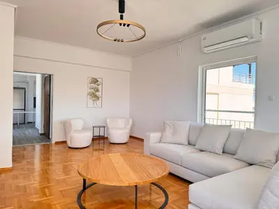 a living room with a couch and a table at Pame Rentals - Terrace Dreams with Pasalimani View in Piraeus