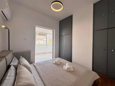 a bedroom with a bed with two towels on it at Pame Rentals - Terrace Dreams with Pasalimani View in Piraeus