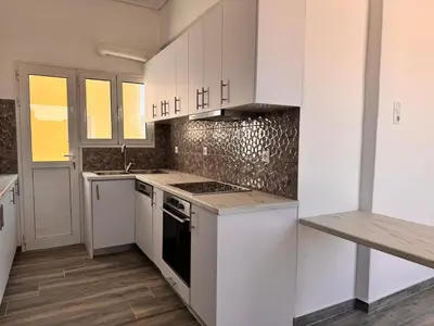 a kitchen with white cabinets and a stove top oven at Pame Rentals - Terrace Dreams with Pasalimani View in Piraeus