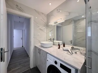 a bathroom with two sinks and a large mirror at Pame Rentals - Terrace Dreams with Pasalimani View in Piraeus