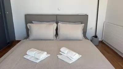 a bed with two white pillows on top of it at Pame Rentals - Terrace Dreams with Pasalimani View in Piraeus