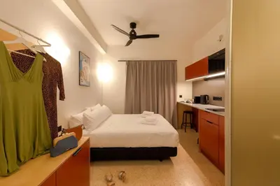a small room with a bed and a kitchen at Mooeve Psyri Studios in Athens