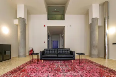 a living room with a black couch and two tables at Mooeve Psyri Studios in Athens