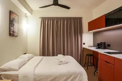 a hotel room with a bed and a kitchen at Mooeve Psyri Studios in Athens
