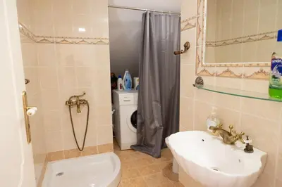 a bathroom with a sink and a toilet and a shower at Aethra Villa in Sounio
