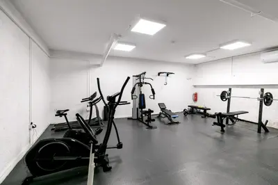 a gym with several treadmills and exercise bikes at Orion - Stunning Studio in Athens in Athens